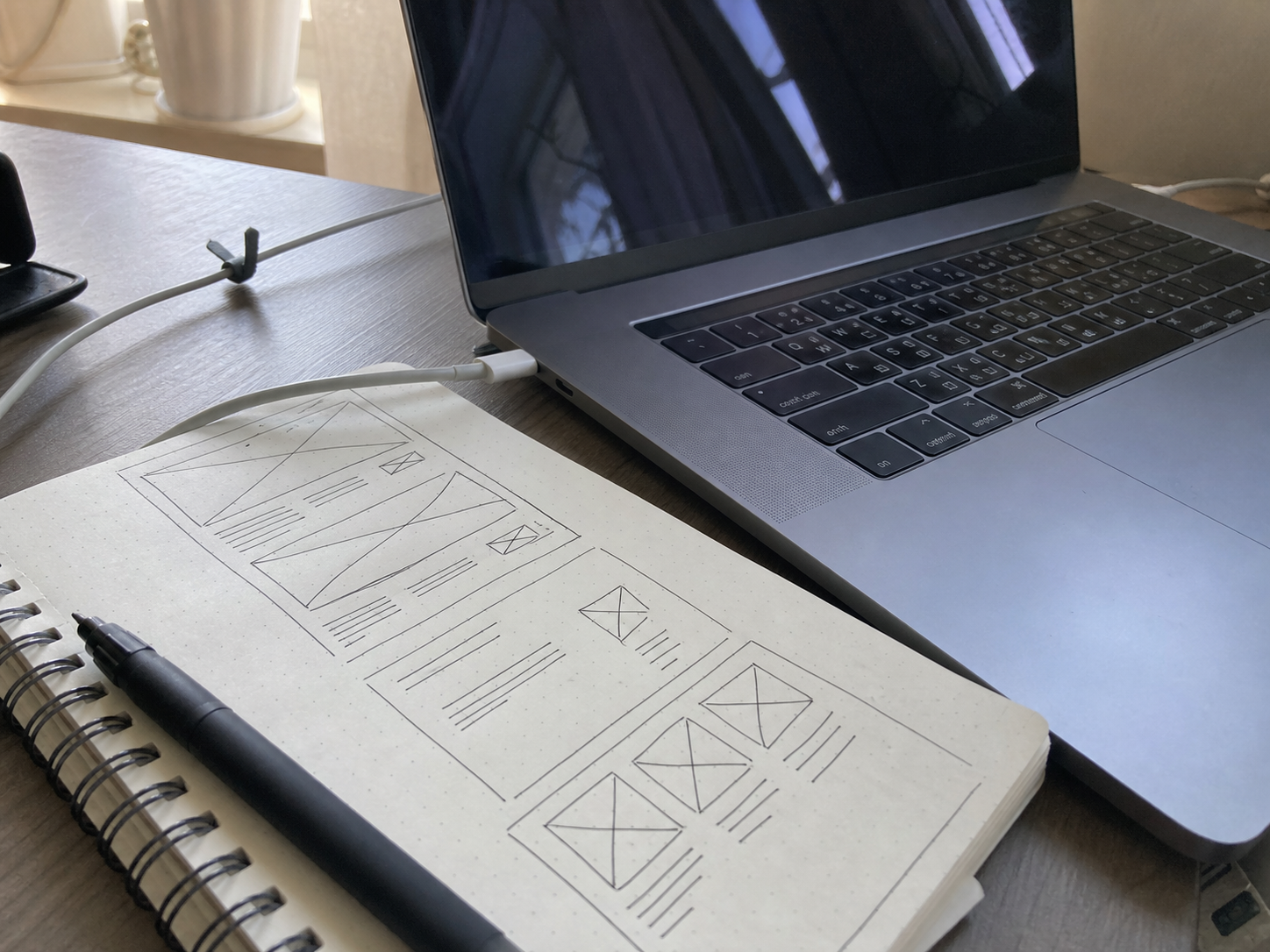 Notebook sketches and laptop during website planning